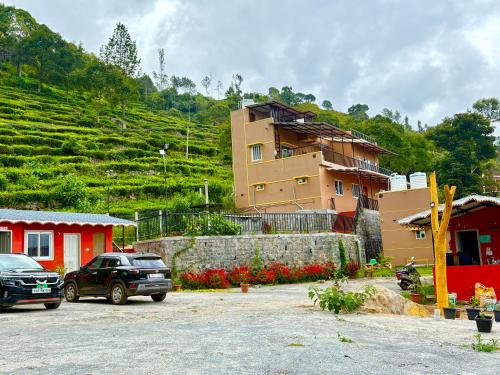 a parking lot with cars parked in front of a building at Humming Bird By Brown Tree Resorts in Kotagiri