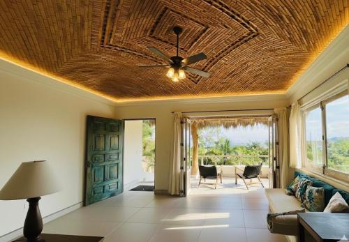 a living room with a ceiling fan and a couch at Casa Cerritos in Sayulita