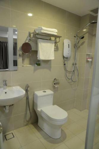 a bathroom with a toilet and a sink at Elegant Hotel in Batu Pahat