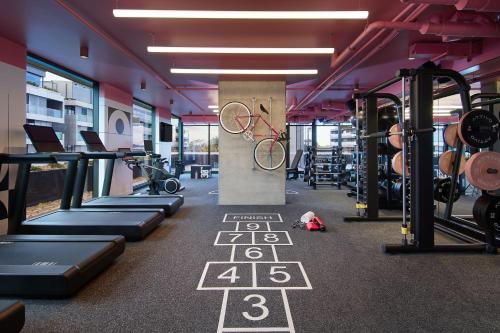 a gym with a bike on a sign in the middle at Moxy Sydney Airport in Sydney
