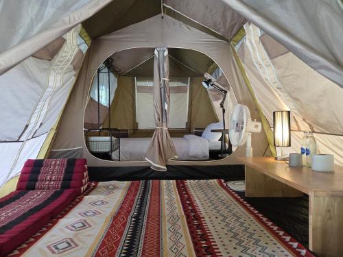 a tent with a bed and a desk in it at iRETREAT Jungle Bliss, Pa Pae in Ban Pa Pae