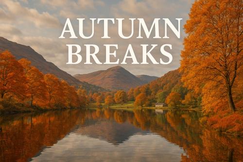 a lake in the middle of a valley with autumn trees at Kents Bank Holiday - Pet Friendly with Bay Views in Grange Over Sands