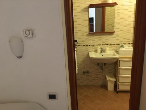 a bathroom with a sink and a mirror at Guest House Dimora Fiorita in Serracapriola