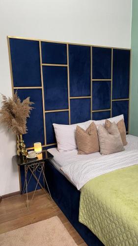 a bedroom with a large bed with blue walls at Двокімнатна квартира з кондиціонером в історичному центрі міста in Chernivtsi