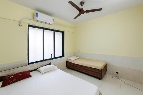 a small room with two beds and a window at Ac Bed with breakfast At ovale naka ghodbunder road thane west in Thane