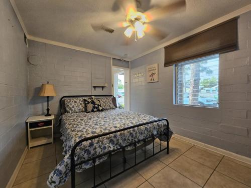 a bedroom with a bed and a ceiling fan at Villa Margarita in Lanark Village