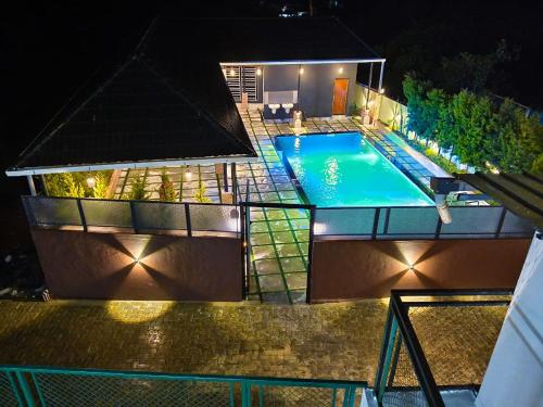 an overhead view of a swimming pool at night at Mount Teena in Anachal