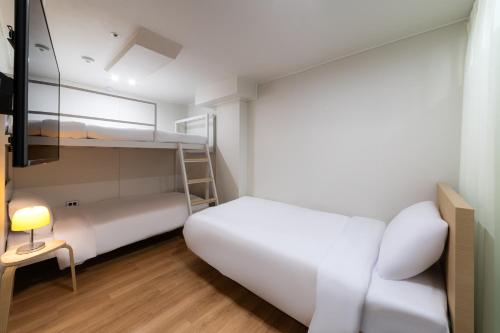 Cama o camas de una habitación en ZIYOLK Myeongdong