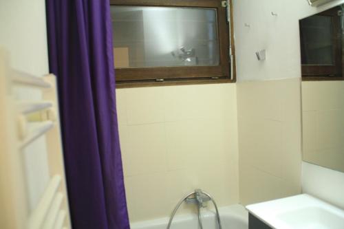a bathroom with a tub and a sink and a window at Toison Blanche TBC45 COSY & Mountain 4 Pers in Châtel