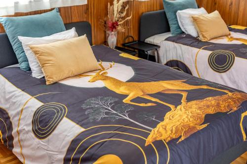 a bedroom with two beds with a blanket with a deer on it at Lax奈良 奈良観光に便利な和モダン古民家 最大12名 グループや家族旅行に最適 in Nara