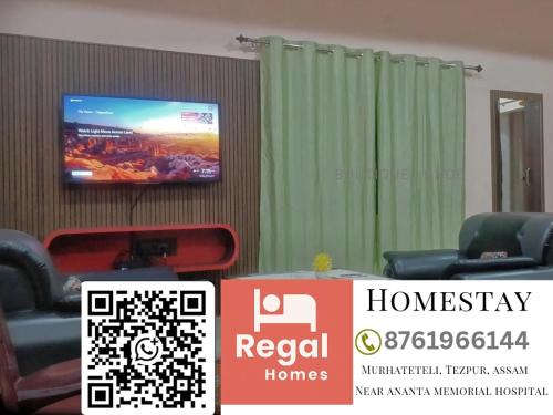a room with chairs and a tv on a wall at Regal homes in Tezpur