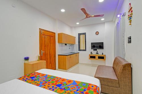 a bedroom with a bed and a kitchen at FabHotel Elegance - Nr US Consulate, Financial District in Hyderabad