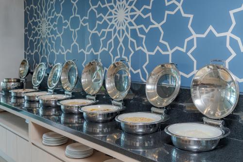 a buffet line with bowls and plates of food at The Yama Hotel Phuket in Kata Beach
