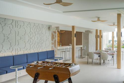 a living room with a foos ball on a table at The Yama Hotel Phuket in Kata Beach