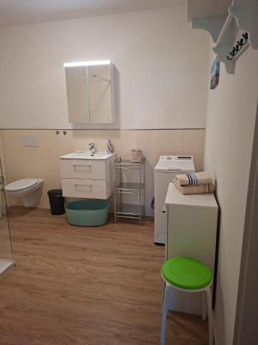 a small bathroom with a sink and a toilet at Apartment On The Upper Floor in Bokelrehm