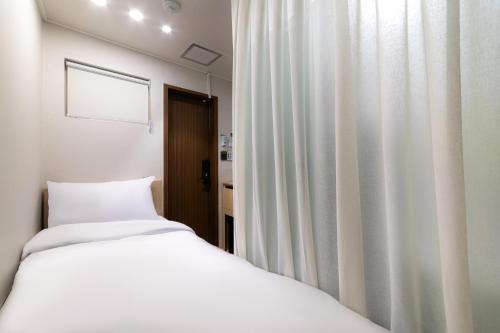 Cama o camas de una habitación en ZIYOLK Myeongdong