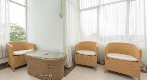 a room with chairs and a table and a window at The Studio Inn Nusa Dua in Ubud