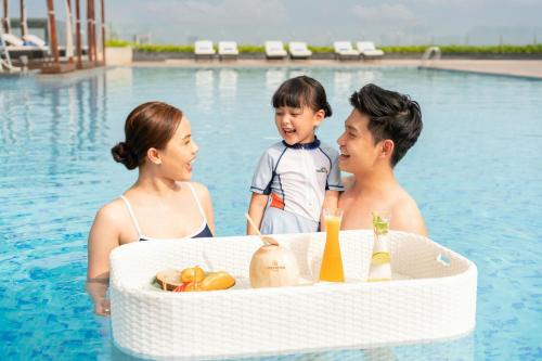 a group of people in a swimming pool at Sheraton Can Tho in Can Tho