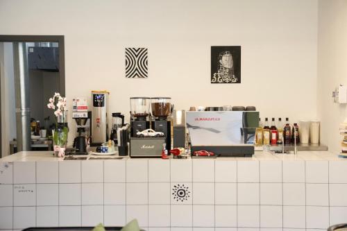 a kitchen with a counter top with many appliances at Palmira Hotel Bishkek in Bishkek