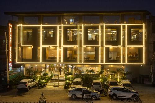 a building with cars parked in front of it at night at Hotel The Prithvi Near Delhi Airport in New Delhi