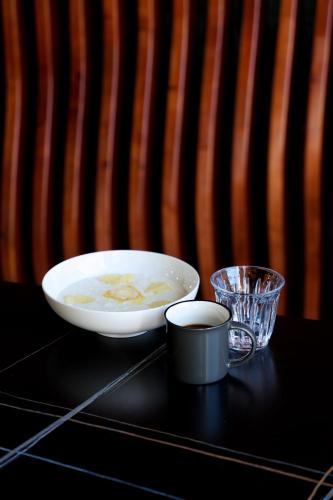 a bowl of food on a table next to a glass at Palmira Hotel Bishkek in Bishkek