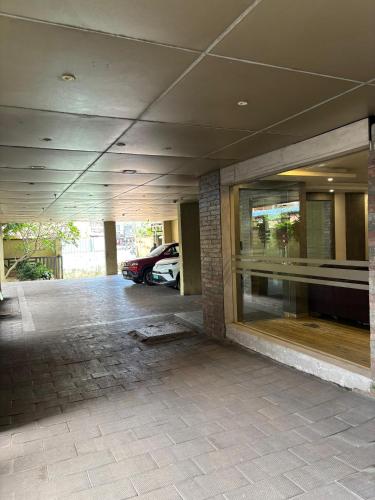 an empty parking lot with a car in a garage at Medora Hotel by Rak Rooms in Kozhikode