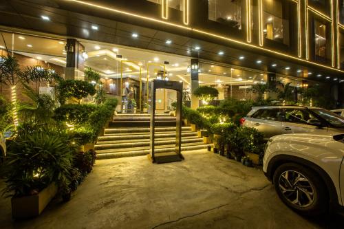 a store front with stairs and a car parked outside at Hotel The Prithvi Near Delhi Airport in New Delhi
