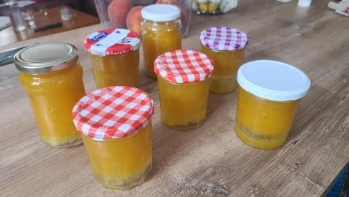 a group of jars of honey on a wooden table at Le N 9 in Argeliers