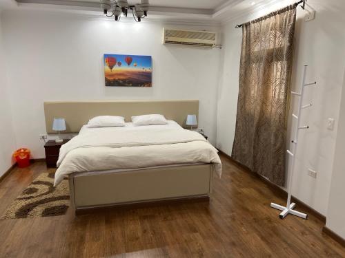 a bedroom with a large bed in a room at luxury dublex with private swimming pool in Obour