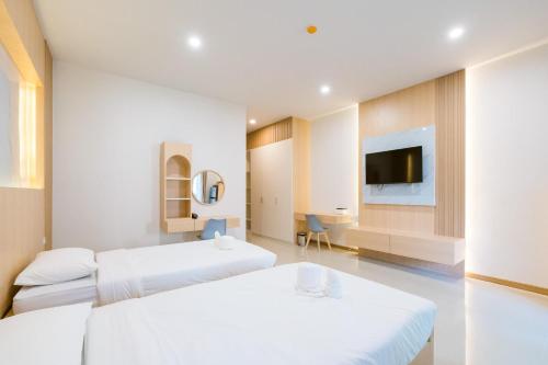Postel nebo postele na pokoji v ubytování Vera Residences Chiang Rai