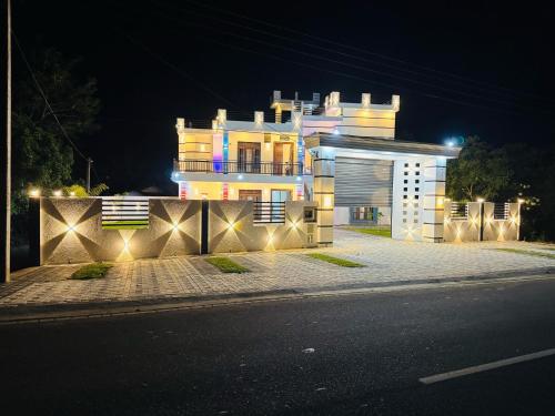 a large white building with lights on the side of a street at Geeth Wild Resort in Tanamalwila