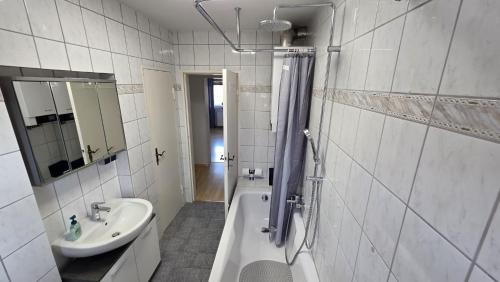 a bathroom with a sink and a bath tub and a toilet at Perfect Living in Petersberg