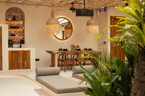 un salon avec des chaises et une table dans l'établissement Kaind - Luxury 4BR Villa with Private Pool and Outdoor Cinema on Gili Trawangan, à Gili Trawangan