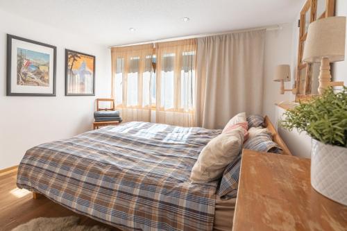 a person laying on a bed in a bedroom at Comfortable apartment for 4-8 persons near Zermatt in Täsch