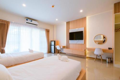 Postel nebo postele na pokoji v ubytování Vera Residences Chiang Rai