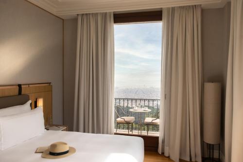 a hotel room with a bed and a large window at METT Barcelona GL - A Leading Hotel of the World in Barcelona