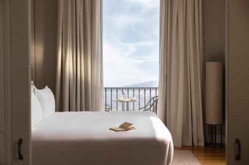 a bedroom with a bed and a large window at METT Barcelona GL - A Leading Hotel of the World in Barcelona