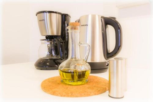 a bottle of oil on a counter next to a blender at Easty Stay Apartments - City Centre in Tallinn