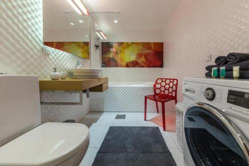 a bathroom with a washing machine in a room at Easty Stay Apartments - City Centre in Tallinn