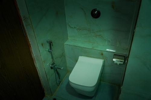 a bathroom with a toilet in a stone wall at Hotel Jaisal Inn - Pure Veg in Jaisalmer