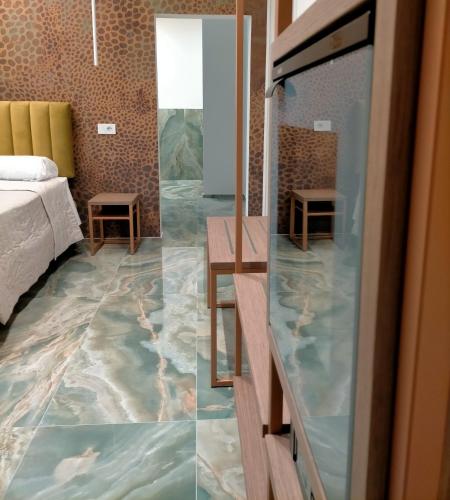 a hotel room with a marble floor and a bedroom at Modus Boutique Hotel in Faenza