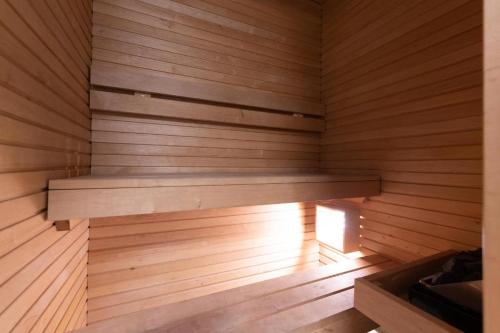 a wooden sauna with a bench in it at Easty Stay Apartments - City Centre in Tallinn