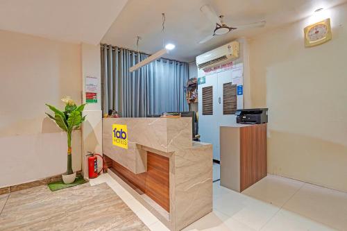 an office with a reception desk and a plant at FabHotel New Empire in Ahmedabad