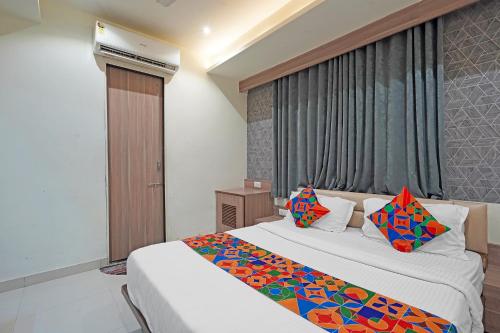 a hotel room with two beds and a window at FabHotel New Empire in Ahmedabad