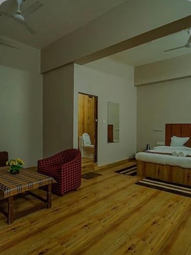 a bedroom with a bed and a couch and a table at Cayana Palms in Sāhān