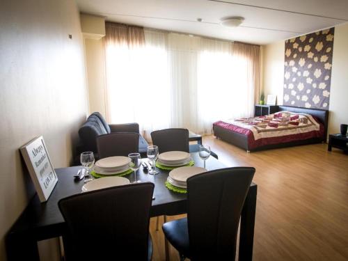 a living room with a table and chairs and a bed at Easty Stay Apartments - City Centre in Tallinn