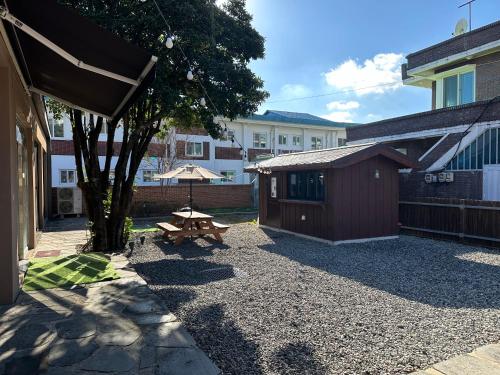 a picnic table and a bench in a courtyard at Private Suncheon House in Suncheon