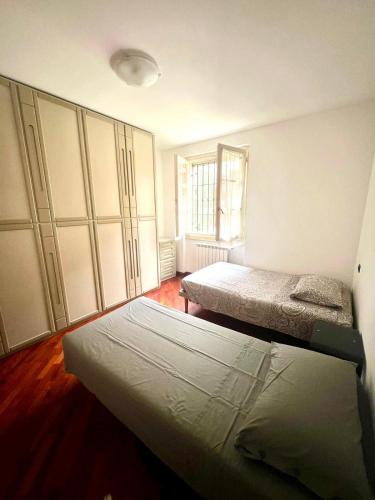 a bedroom with two beds and a large closet at Cuore della Città- Manerbio in Manerbio