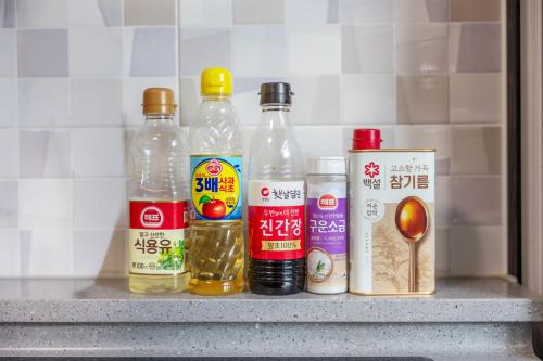 a shelf with bottles of food and spices on it at Private Suncheon House in Suncheon