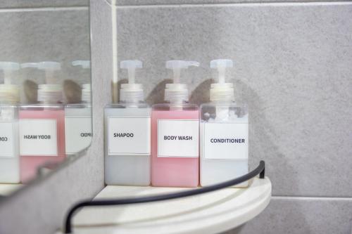 a group of bottles on a shelf in a bathroom at Private Suncheon House in Suncheon